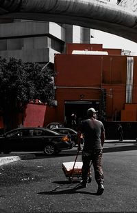 Rear view of man standing on city street