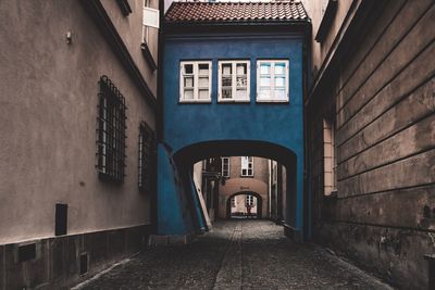 Empty alley amidst buildings in city