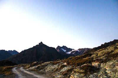 Scenic view of mountains against clear blue sky