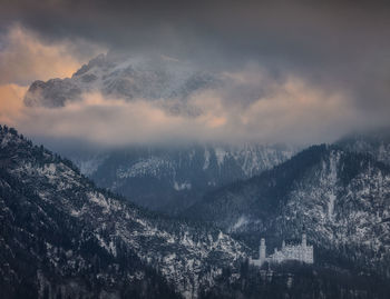 Scenic view of snowcapped mountains against sky during sunset