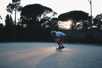 Full length of man skateboarding at playground during sunset