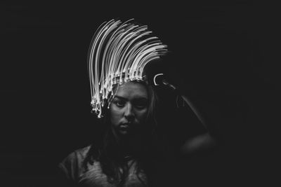 Portrait of young man with light painting in darkroom