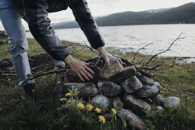 Man holding rocks on field