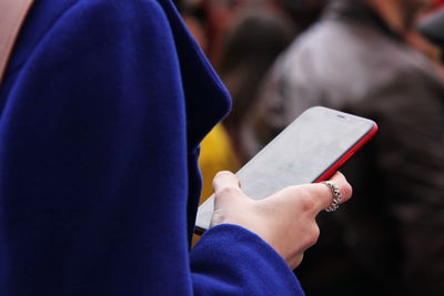 Women's hands holding the phone. the use of a touch phone and modern technology.