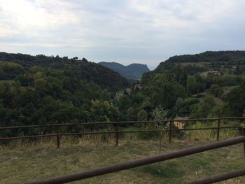 Scenic view of mountains against cloudy sky