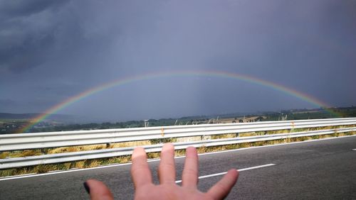Scenic view of rainbow over city against sky