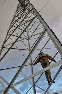 Low angle view of electricity pylon against sky