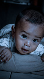 Portrait of cute boy lying on bed