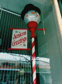 Low angle view of sign on street against building
