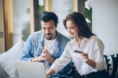 Young couple sitting on mobile phone