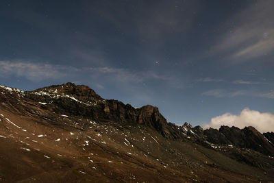 Scenic view of mountains against sky at night