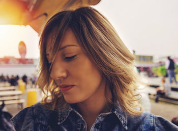 Close-up of beautiful woman looking away in amusement park