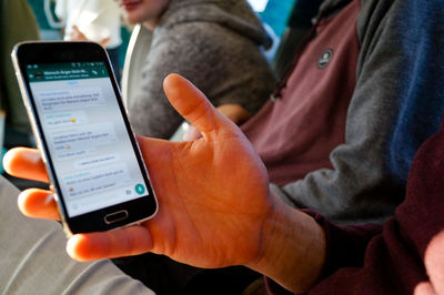 Midsection of man using mobile phone