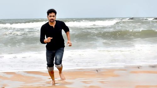 Full length of man standing on beach