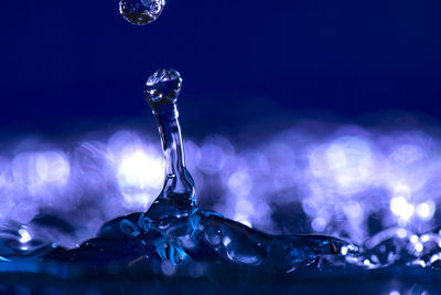 Close-up of water drop against blue background