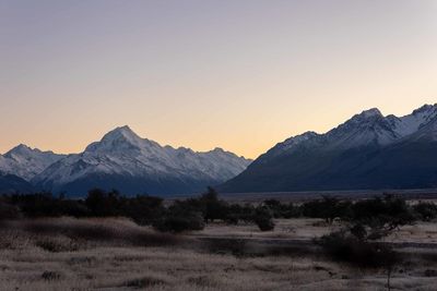 Scenic view of snowcapped mountains against clear sky