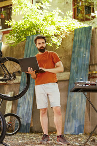 Portrait of young man using digital tablet