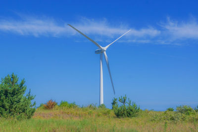 Low angle view of windmill against sky