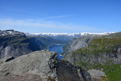 Scenic view of mountains against blue sky