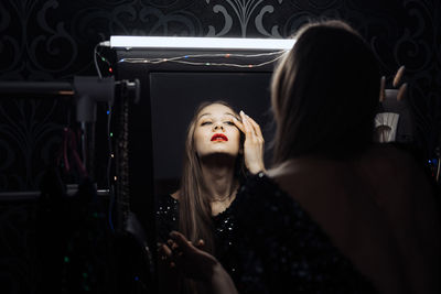 New years eve makeup ideas. beautiful young woman bright evening make-up red lips getting ready for