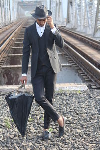 Full length of man walking on railroad track