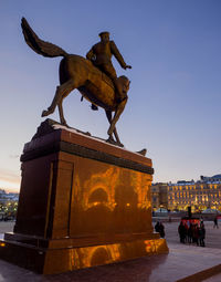Statue against sky in city