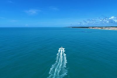 Scenic view of sea against blue sky