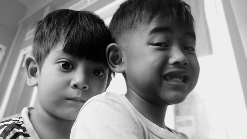 Close-up portrait of brothers at home