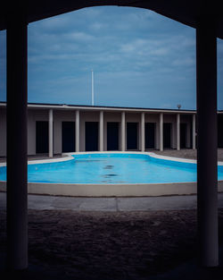 View of swimming pool against cloudy sky