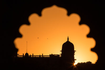 Silhouette of building against sky during sunset