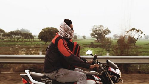 Rear view of man riding motorcycle