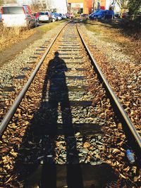 Shadow of people on railroad tracks