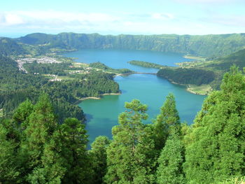 High angle view of lake amidst trees against sky