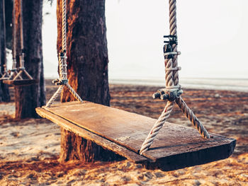 Close-up of swing hanging on rope