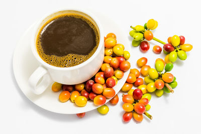 High angle view of coffee beans against white background