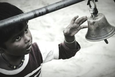 High angle view of cute girl looking at bell