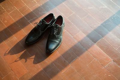 High angle view of black shoes on tiled floor