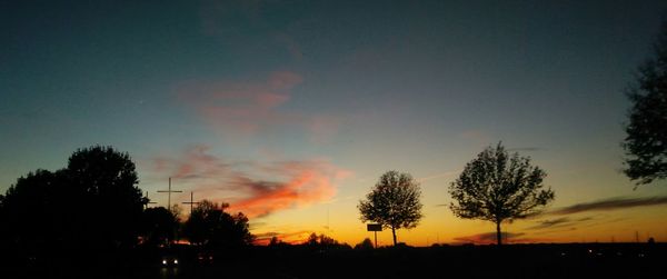 Silhouette trees against sky during sunset