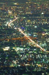 Aerial view of illuminated cityscape against sky at night