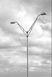 Low angle view of street light against cloudy sky
