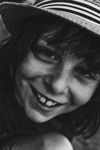 Close-up portrait of smiling girl wearing hat