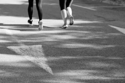 Low section of people walking on street