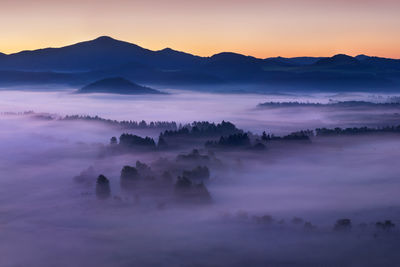 Scenic view of silhouette mountains against sky during sunset