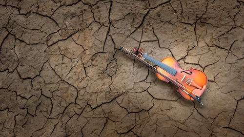 High angle view of guitar on barren land