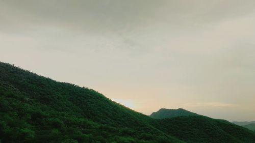 Scenic view of mountains against cloudy sky