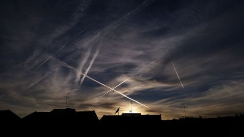 Silhouette buildings against sky during sunset