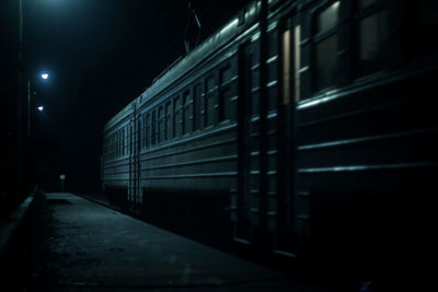 Train on illuminated building at night