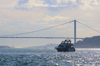 View of bridge over sea against cloudy sky