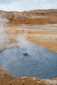 Scenic view of geyser against sky