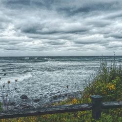 Scenic view of sea against cloudy sky